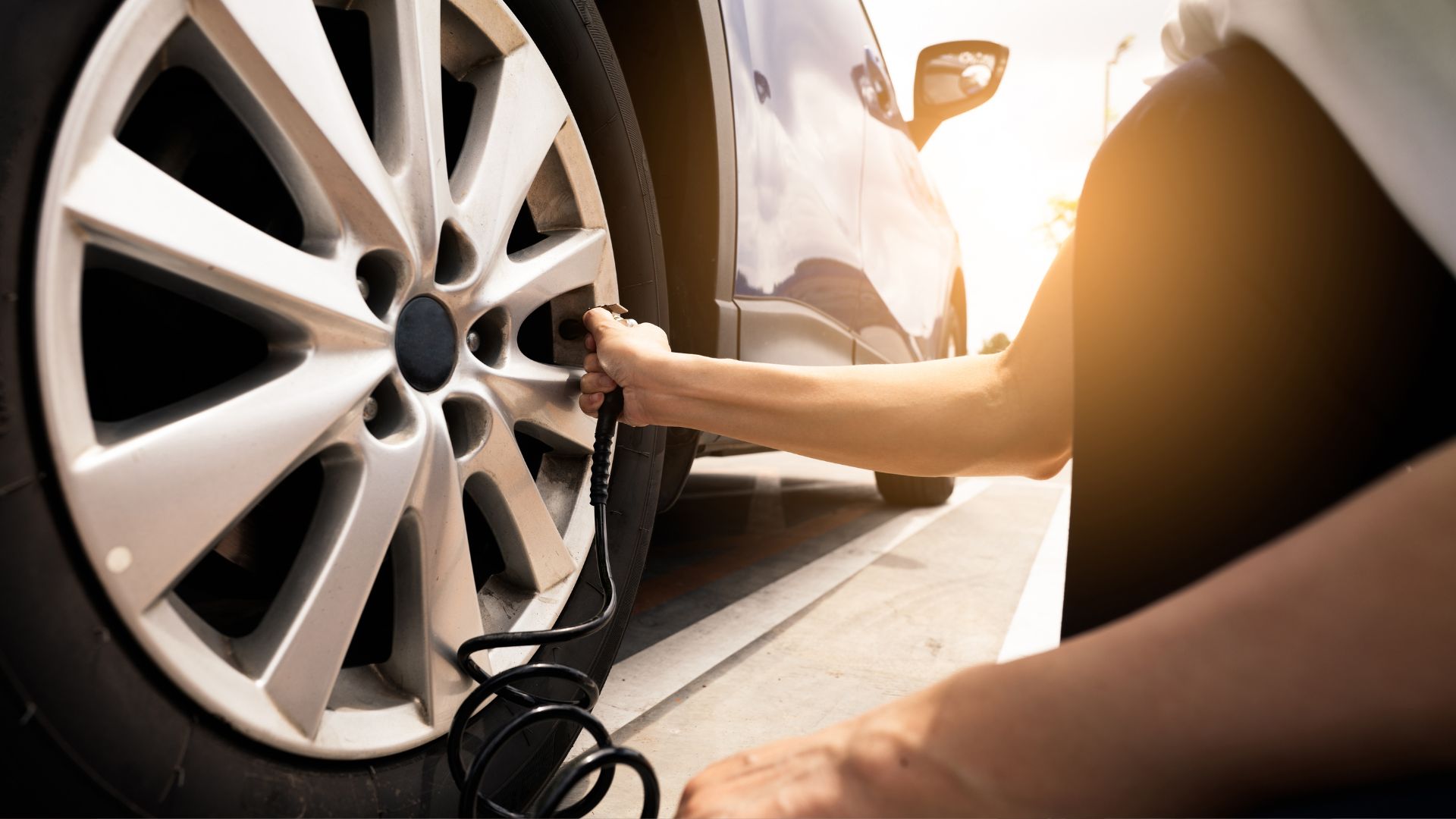 A person is changing the tire of a car