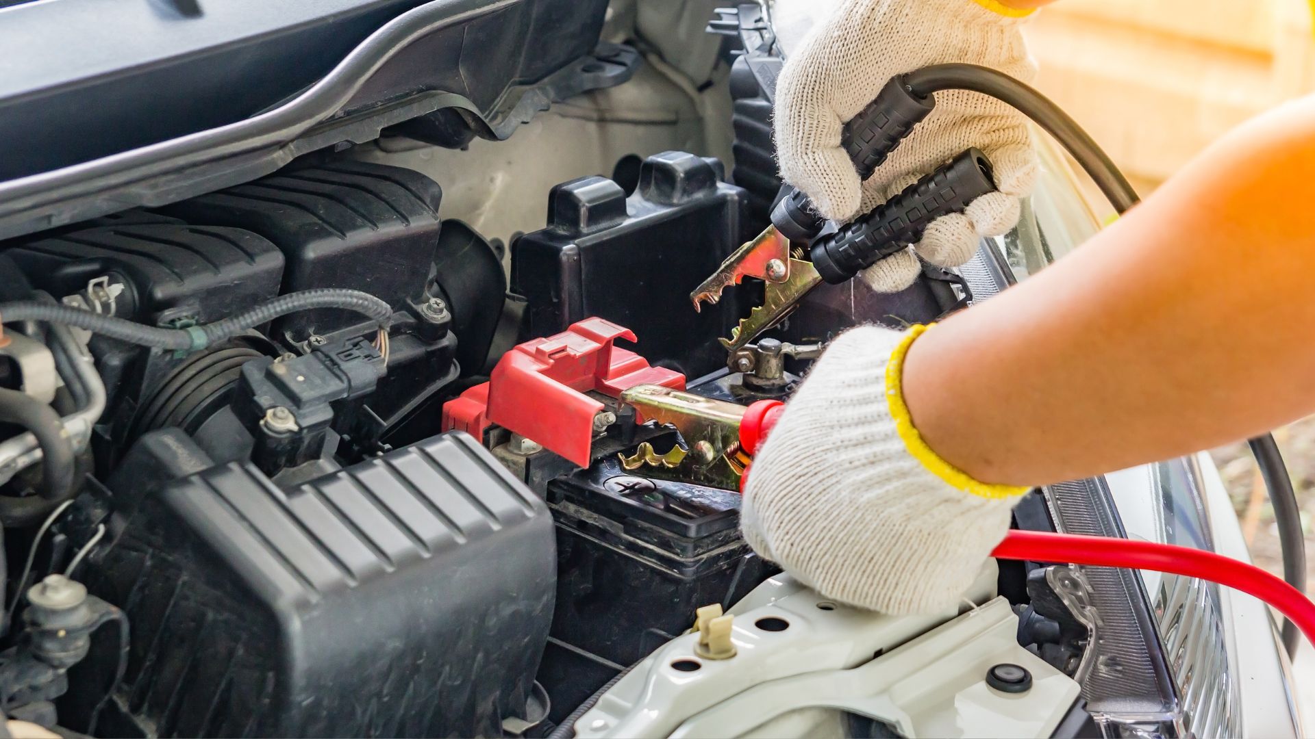 A person is working on a car's engine