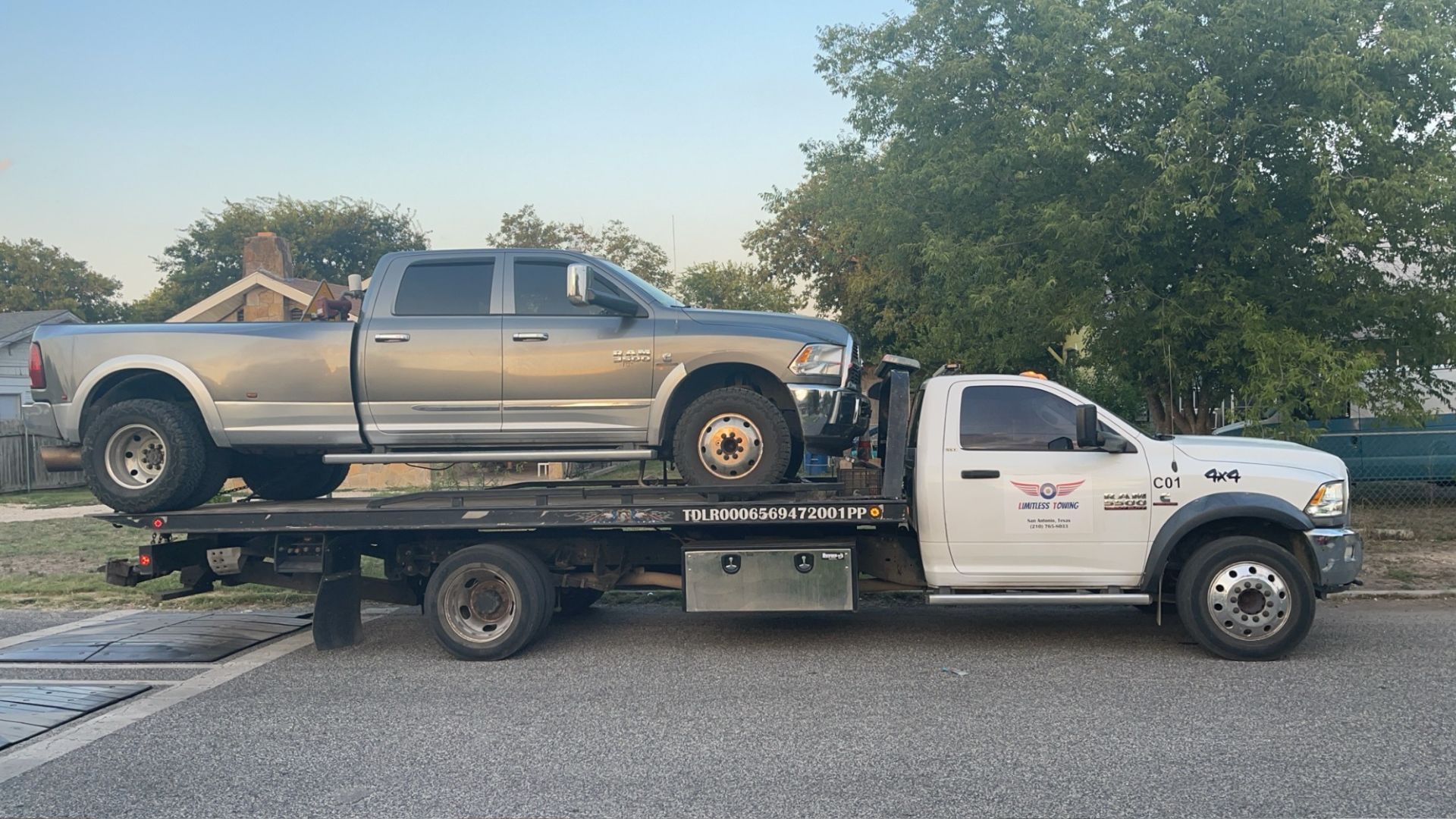 A silver truck with a flat bed on the back of it