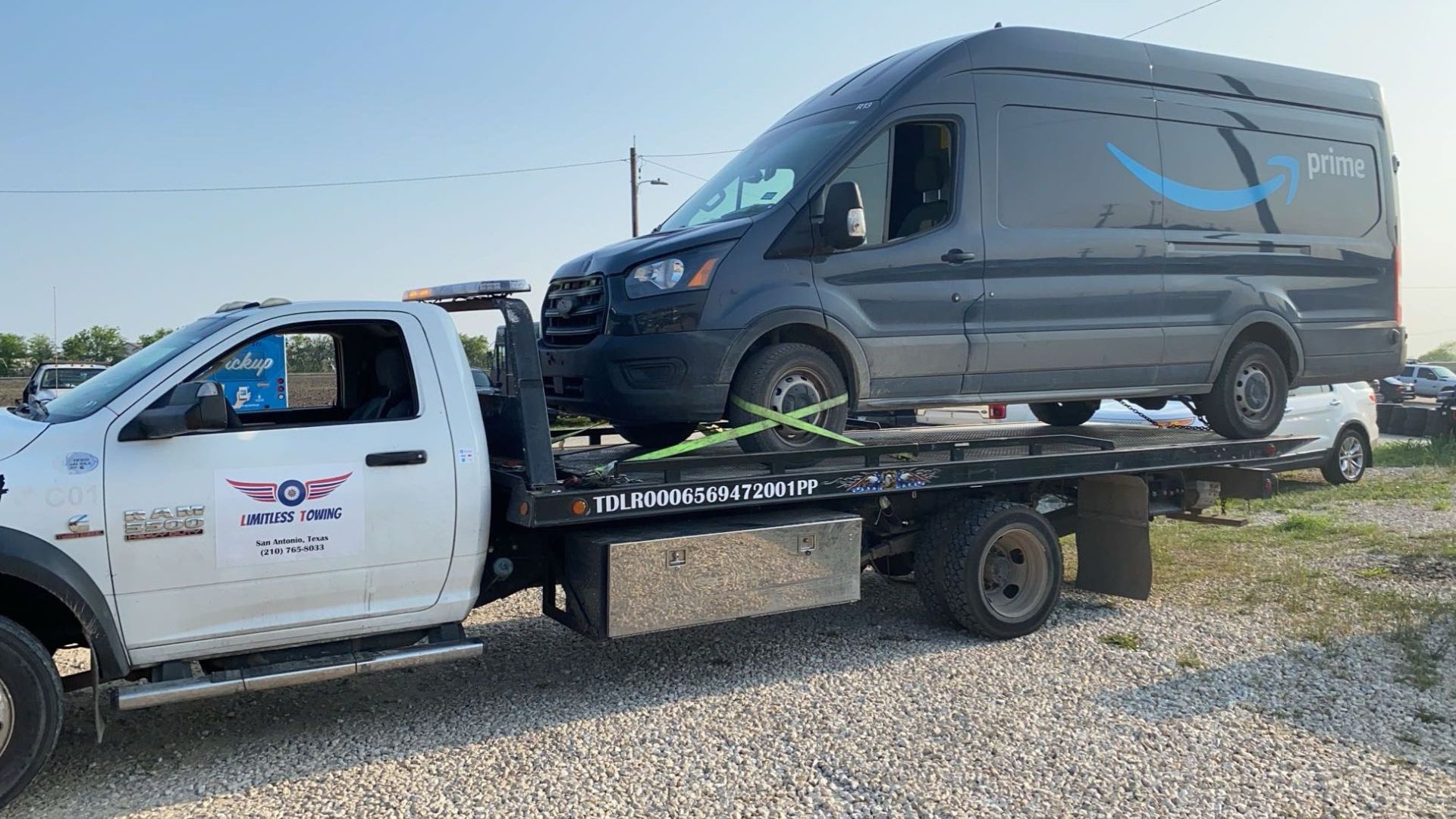 A white truck with a black van on the back of it